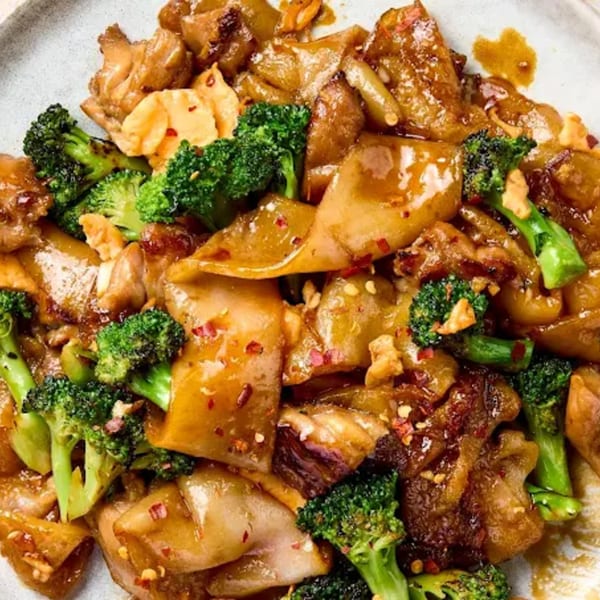 Close-up of Made in Asia's Thai Pad See Ew with wide noodles, chicken, and broccoli.