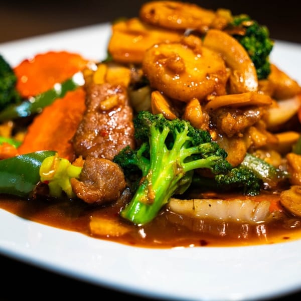 Close-up of Made in Asia's Thai stir-fry with broccoli, carrots, and meat in a rich sauce.